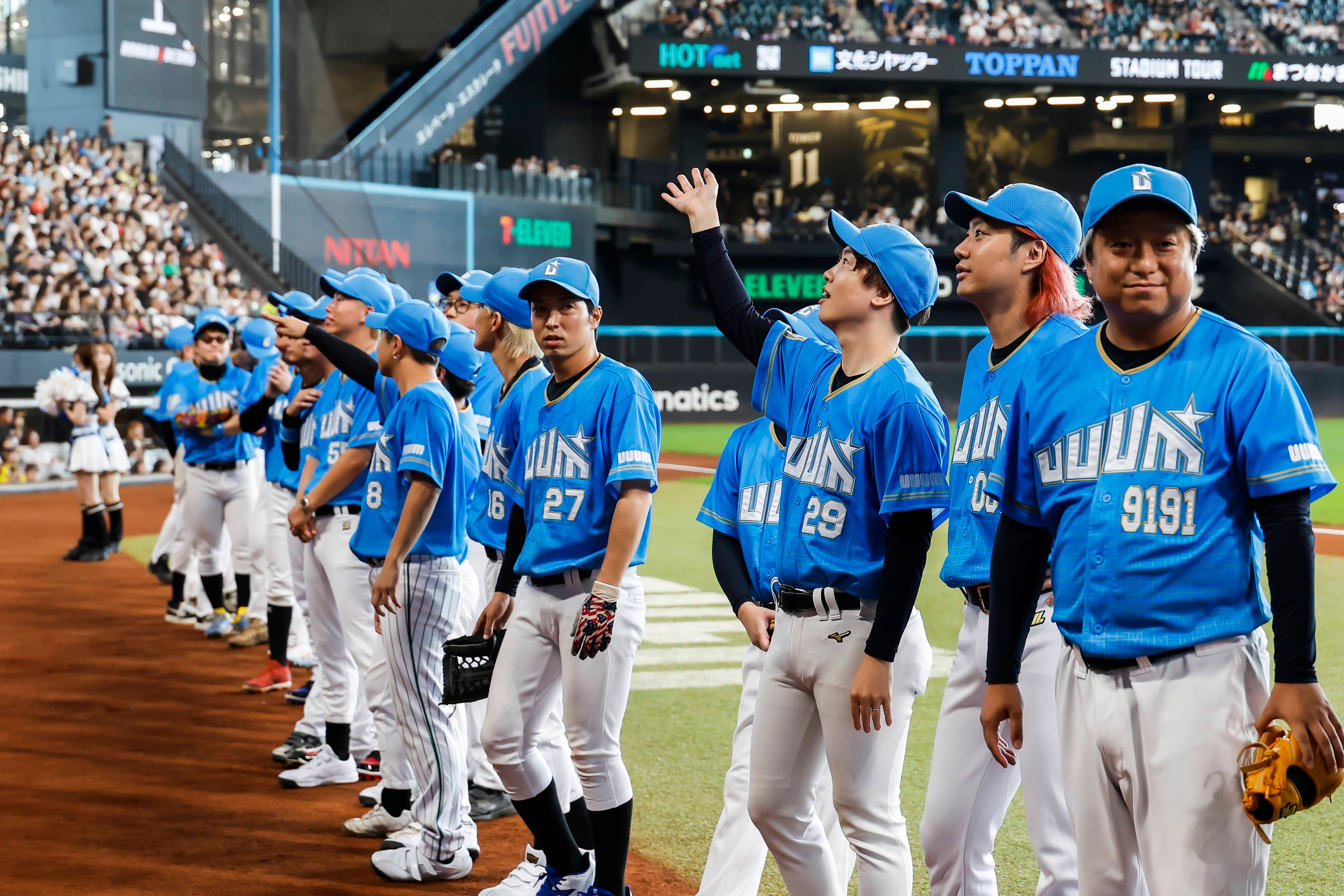 試合後、UUUM DAYの出演者たちがグラウンド上に並んで観客へ手を振る様子。